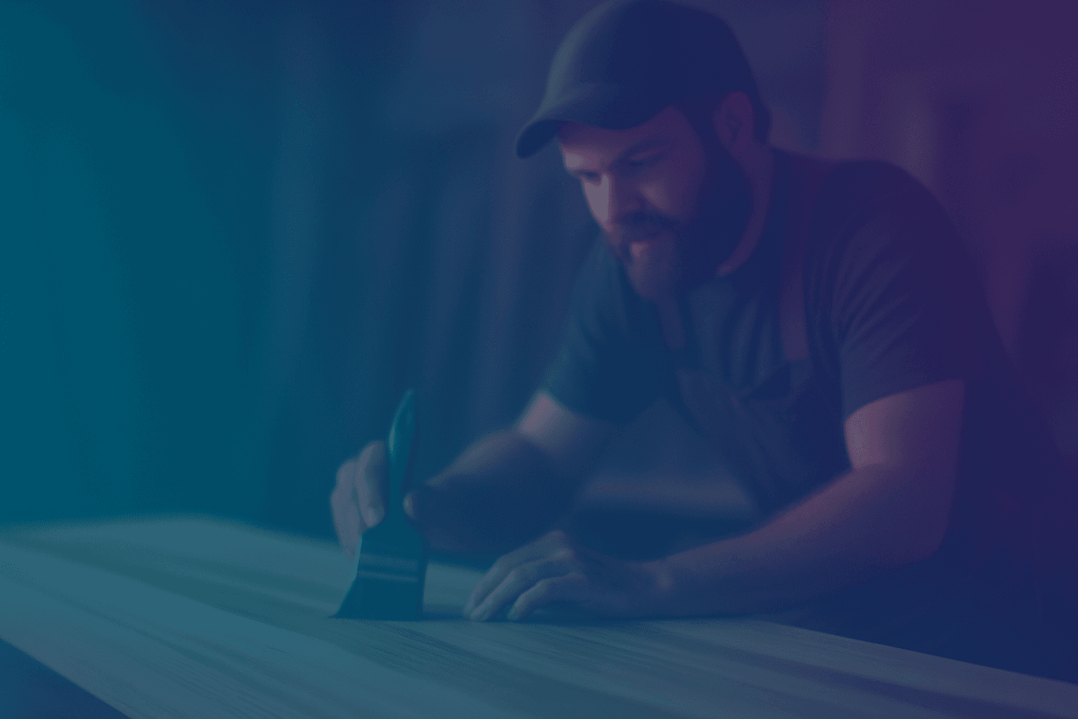 Woodworker applying finish in workshop